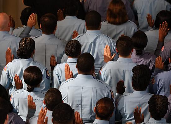 Officers raising their hands